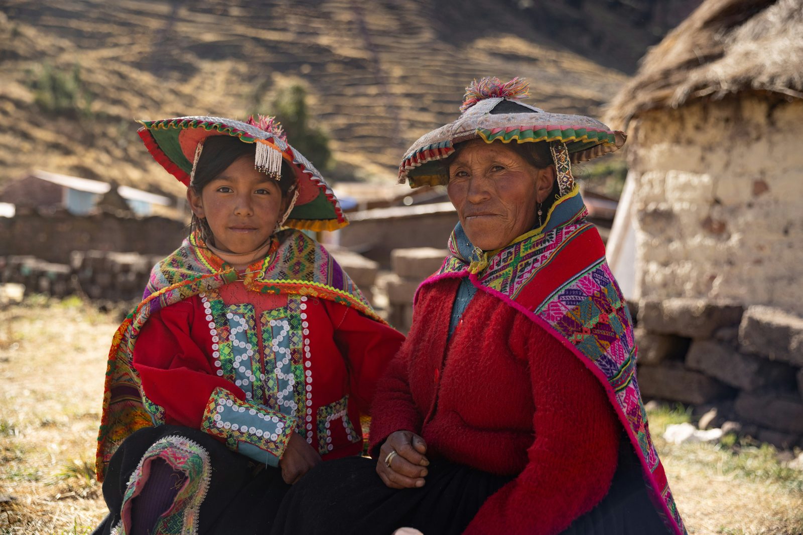 Two Quechua women outside a traditional Andean home. In communities like these, language is not only a tool for communication but also carries deep cultural responsibilities. Photo by Gustavo Leighton on Unsplash